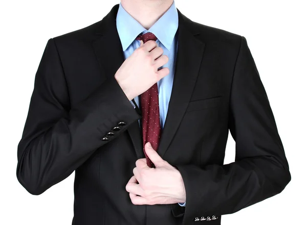 Бизнесмен поправляет галстук крупным планом — стоковое фото