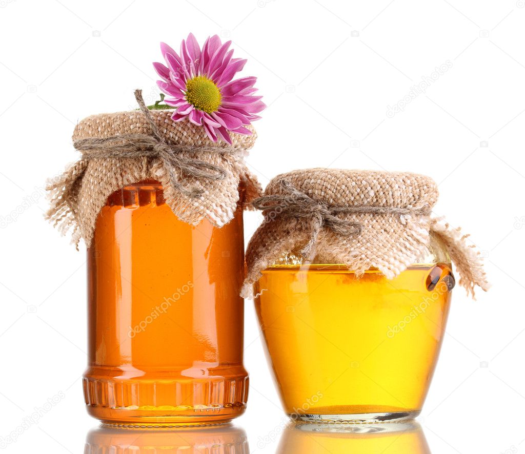 Sweet honey in jars isolated on white