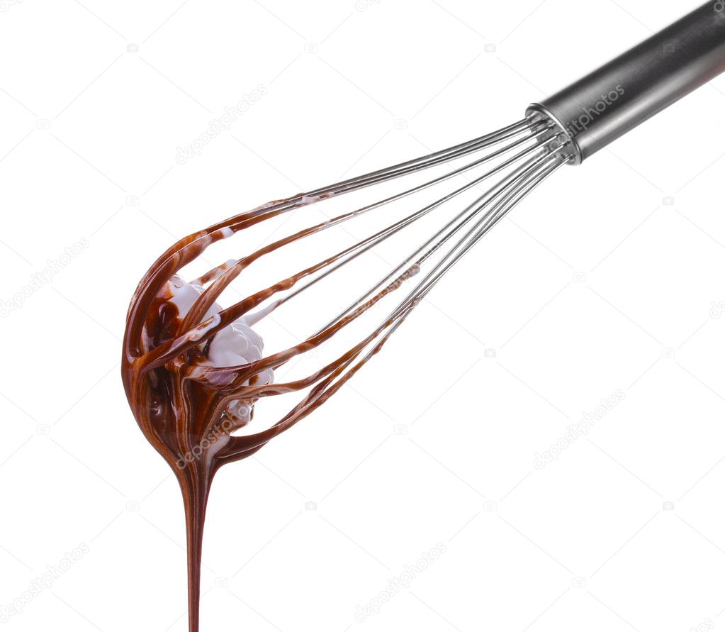 Metal whisk for whipping eggs with chocolate cream isolated on white