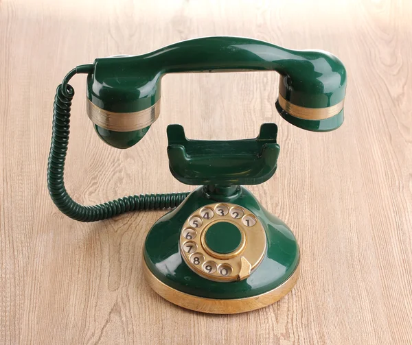 Retro phone with floating handset on wooden background — Stock Photo, Image