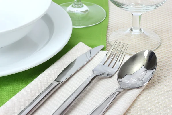 Configuração de mesa com garfo, faca, colher, pratos e guardanapo — Fotografia de Stock