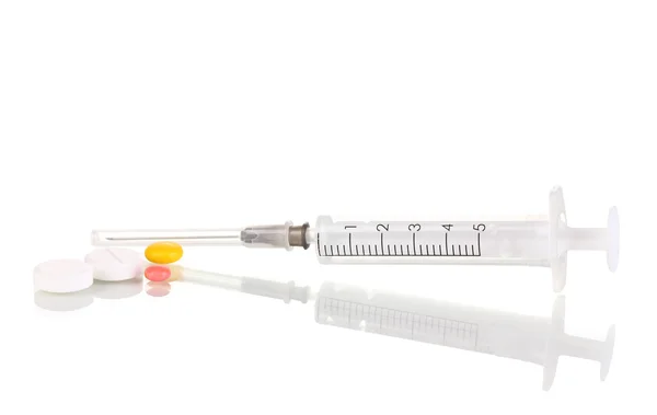 Syringe and tablets isolated on white — Stock Photo, Image