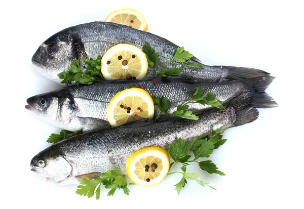 stock image Fresh fishes with lemon, parsley and spice isolated on white