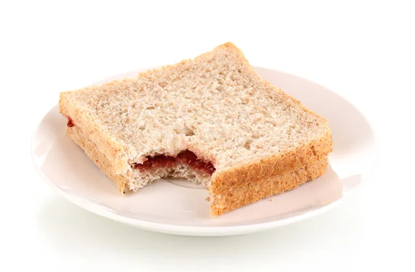 Δαγκωμένη σάντουιτς με μαρμελάδα στο πιάτο που απομονώνονται σε λευκό — Φωτογραφία Αρχείου