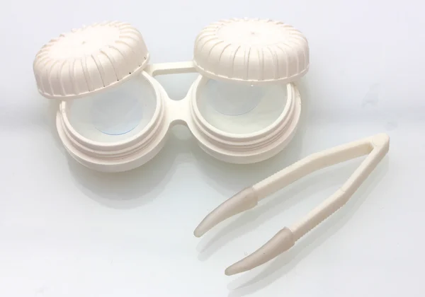 Kontaktlinser i behållare och pincett isolerad på vit — Stockfoto
