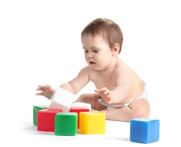 Cute baby girl playing with cubes isolated on white Stock Photo