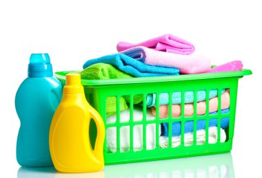 Detergents and towels in green plastic basket isolated on white clipart