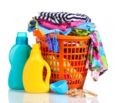 Clothes with detergent and washing powder in orange plastic basket isolated on white clipart