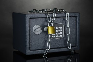 Safe with chain and lock on grey background clipart