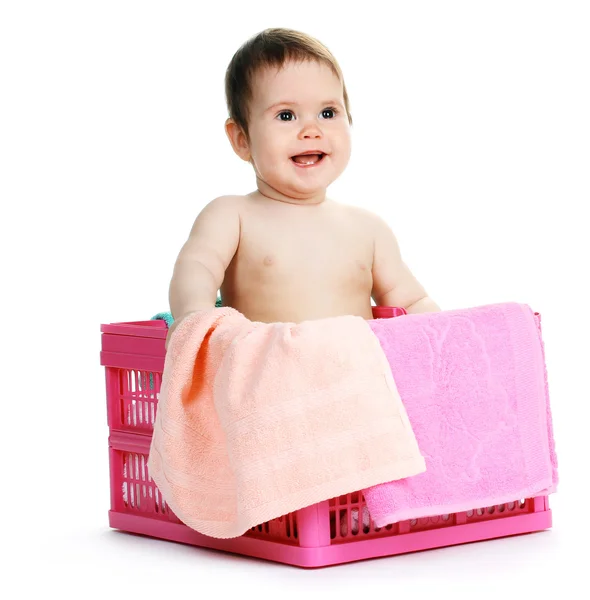 Cute baby girl sitting in laundry basket isolated on white — Stock Photo, Image