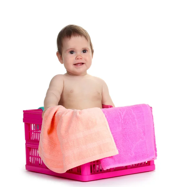 Cute baby girl sitting in laundry basket isolated on white — Stock Photo, Image