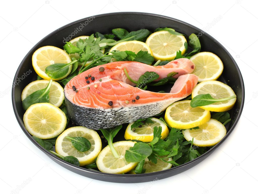 Red fish with lemon, parsley and pepper on plate isolated on white