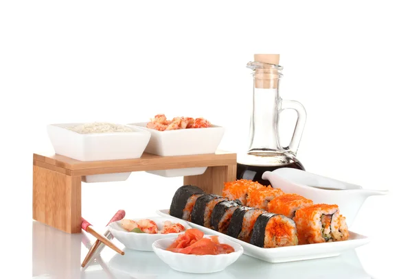 Delicious sushi on plate, chopsticks, soy sauce, fish and shrimps isolated on white — Stock Photo, Image