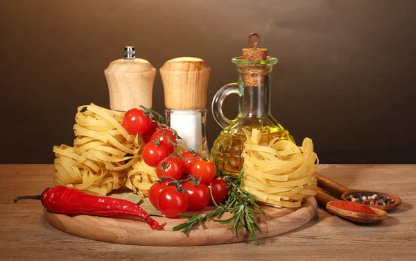 ボウル、オイル、スパイスと野菜ブラウン バック グラウンドに木製のテーブルの上の瓶に麺 — ストック写真