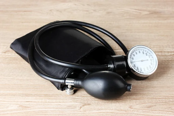 stock image Black tonometer on wooden background