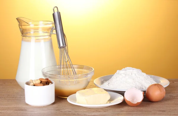 Ingredients for the dough wooden table on yellow background — Stock Photo, Image