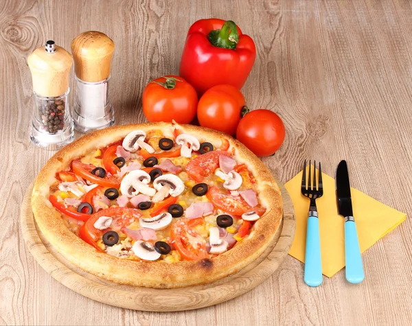 Aromatic pizza with vegetables on wooden background — Stock Photo, Image