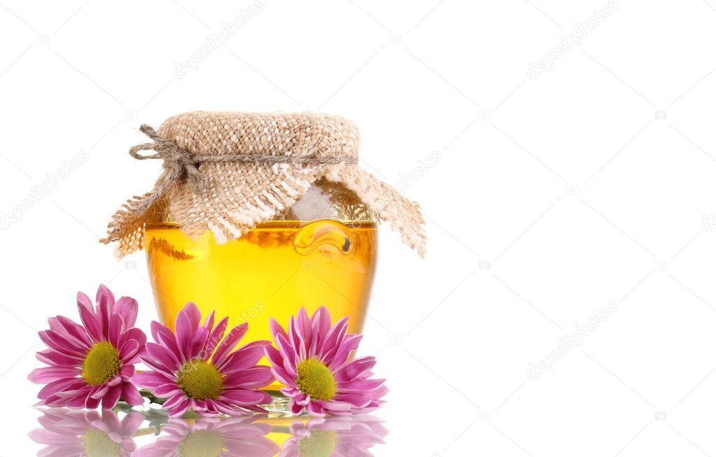 Sweet honey in jar isolated on white
