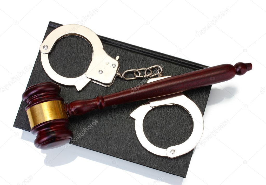 Wooden gavel, handcuffs and book isolated on white
