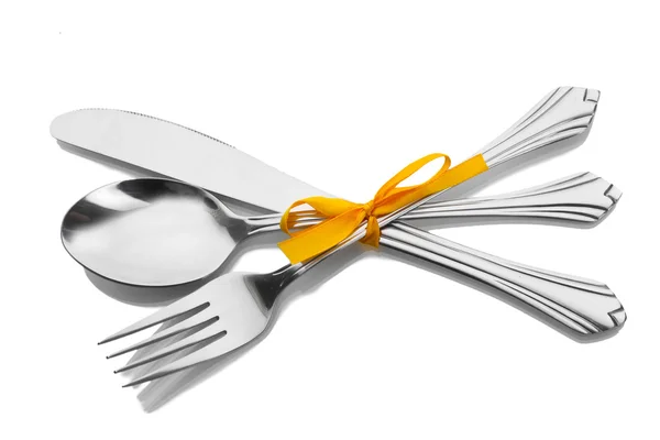 Silver fork and spoon, knife tied with a yellow ribbon isolated on white — Stock Photo, Image