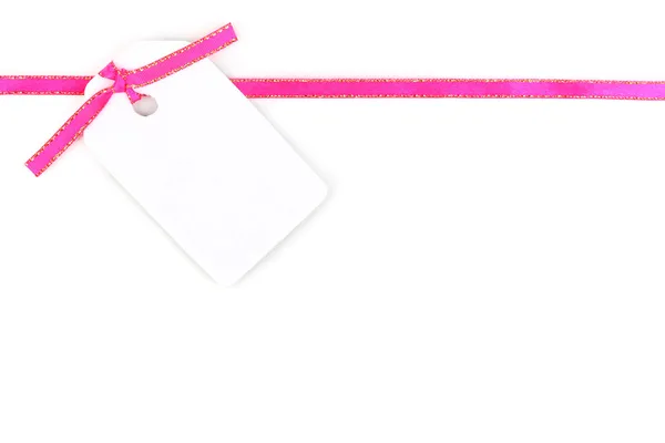Blank gift tag with pink satin ribbon isolated on white — Stock Photo, Image