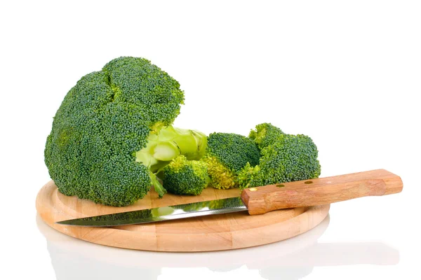 Broccoli on wooden chopping board isolated on white — Stock Photo, Image