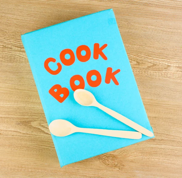 Naczynia kuchenne na drewniane tła i książka kucharska — Zdjęcie stockowe