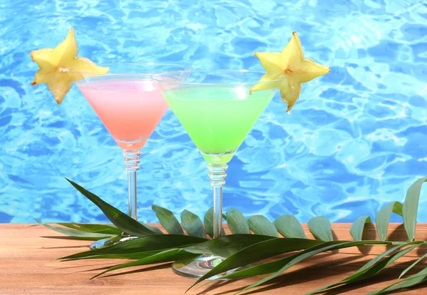 Glasögon av cocktails på träbord på blå havet bakgrund — Stockfoto