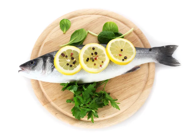 Fresh fish with lemon, parsley and pepper on wooden cutting board isolated on white — Stock Photo, Image