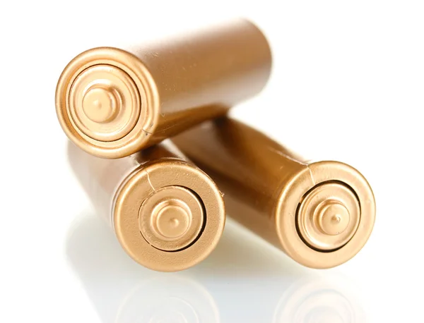 Tres baterías de oro aisladas en blanco — Foto de Stock
