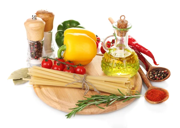 Espaguetis, tarro de aceite, especias y verduras sobre tabla de madera aislada sobre blanco — Foto de Stock