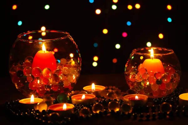 Wonderful composition of candles on wooden table on bright background Royalty Free Stock Photos