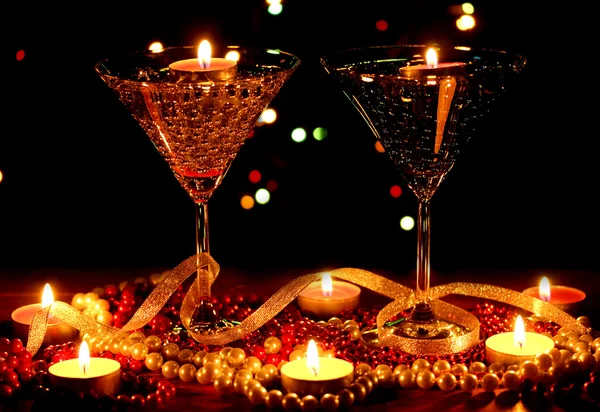 Verbazingwekkende samenstelling van kaarsen en bril op houten tafel op lichte achtergrond — Stockfoto