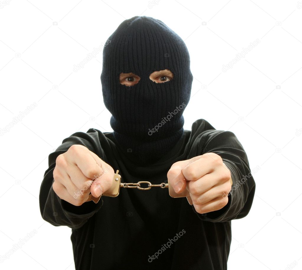 Bandit in black mask handcuffed isolated on white