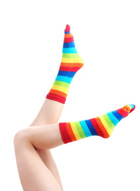 Female legs in colorful striped socks isolated on white clipart