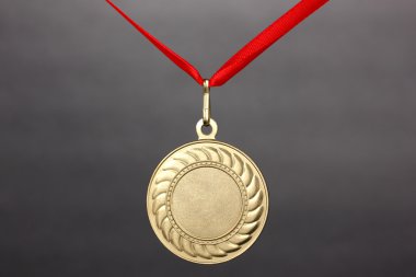 Gold medal on grey background clipart