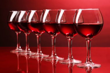 Wineglasses on red background clipart