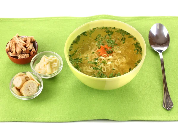 Tasty chicken stock with noodles on green tablecloth — Stock Photo, Image