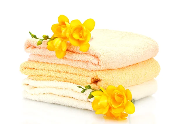 Colorful towels and flowers isolated on white — Stock Photo, Image