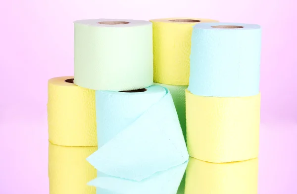 Bright rolls of toilet paper on pink background — Stock Photo, Image