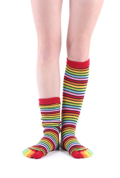 stock image Female legs in colorful striped socks isolated on white