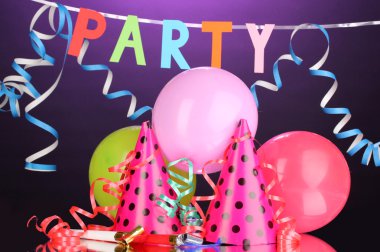 Party items on purple background clipart