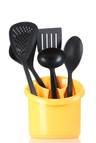 Black kitchen utensils in yellow stand isolated on white — Stock Photo, Image