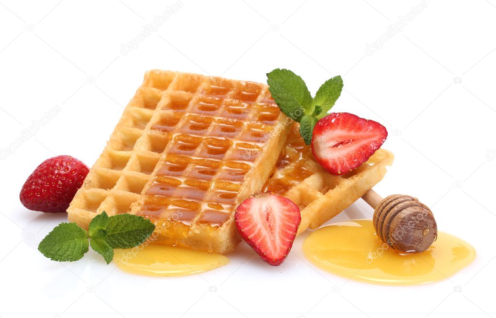 Belgium waffles with honey, strawberries and mint isolated on white