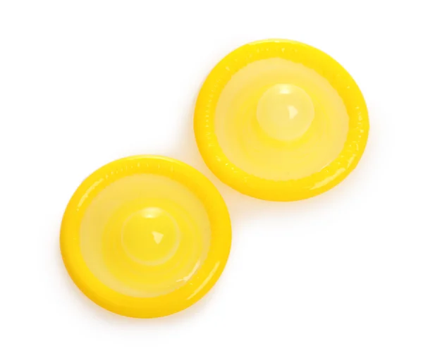 stock image Two yellow condoms isolated on white