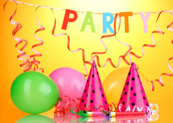 Party items on orange background — Stock Photo, Image