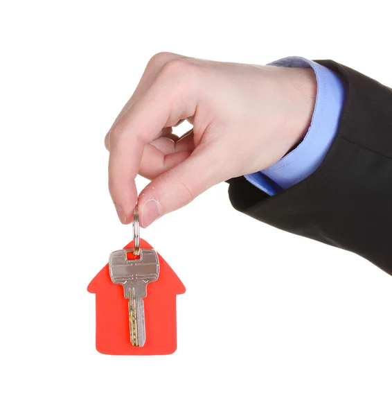 Nyckel med hus-formade charm i hand isolerad på vit — Stockfoto