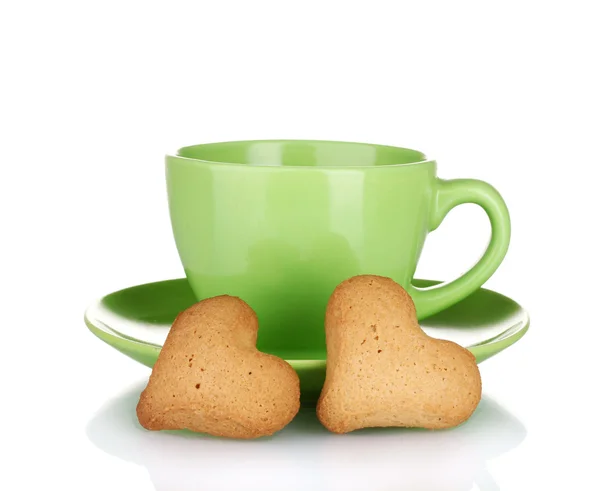 Zelená šálek a talířek s srdce tvaru cookies izolovaných na bílém — Stock fotografie