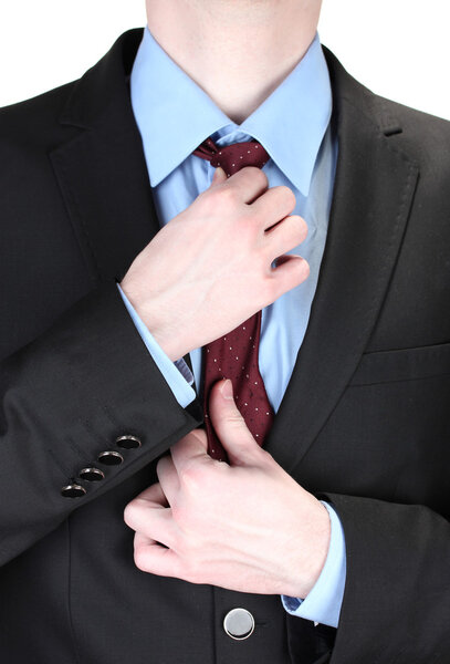 Businessman correcting a tie close up