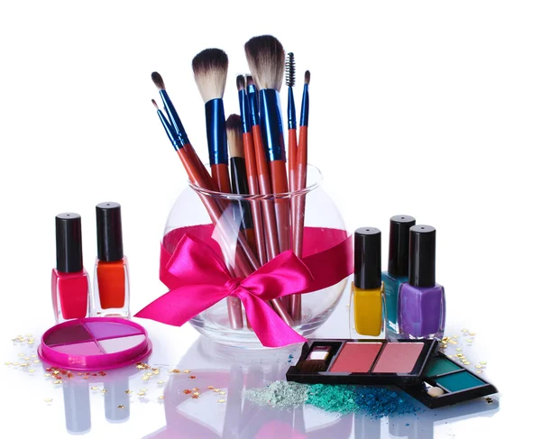 Make-up brushes in glass vase and cosmetics isolated on white — Stock Photo, Image